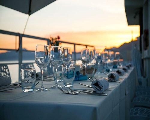 A tranquil family dining table setting with fresh salads and local water jugs